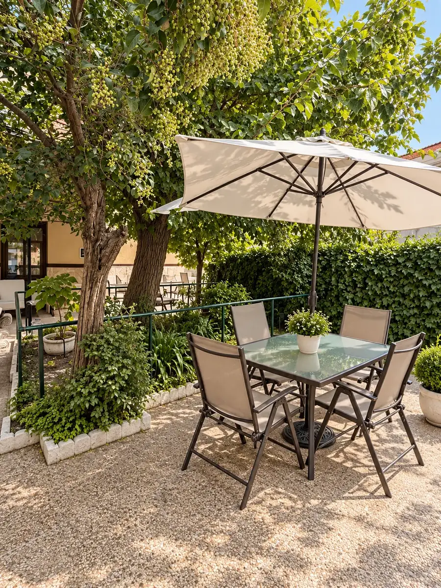 Mesa con sombrilla bajo los árboles del jardín